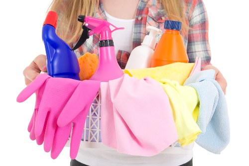 Staff handling cleaning products and checking labels safely