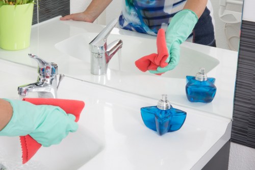 Office cleaners disinfecting kitchen and washroom areas in W1