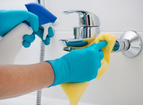 Commercial cleaners vacuuming and polishing floors in a W1 office